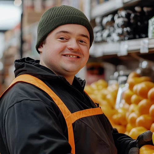 Young man with Down syndrome working in grocery store.