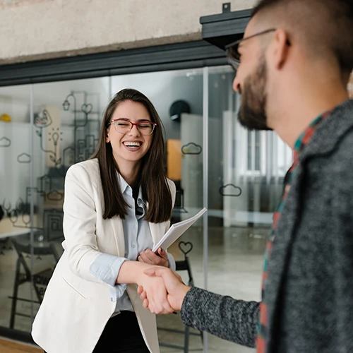 Handshaking and smiling candidly at a job interview 