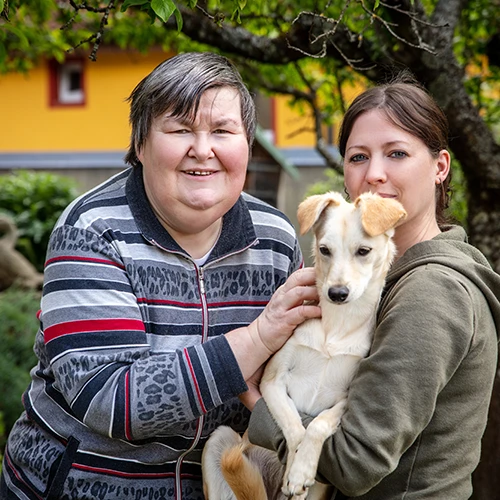 woman with caregiver and dog